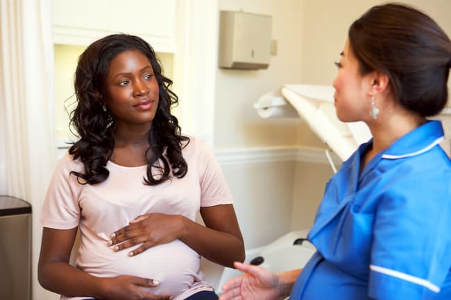 photo of pregnant woman at doctor appointment