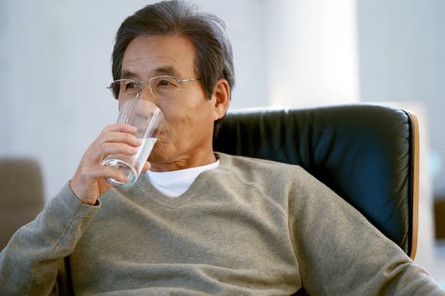 photo of man drinking water